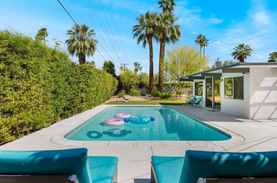 Enjoy a beautiful pool area surrounded by a vibrant desert garden