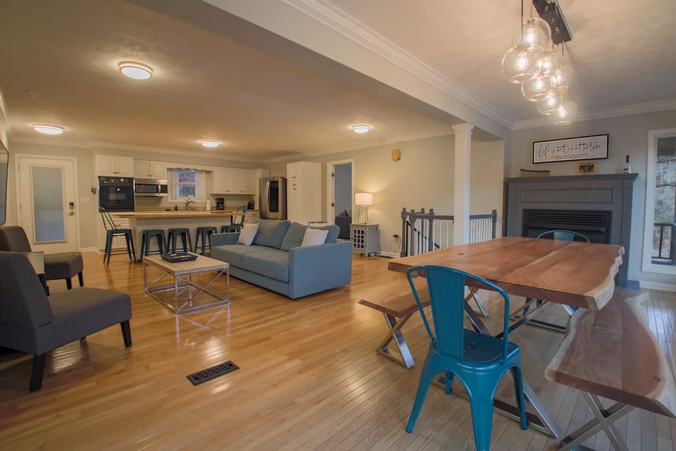 Main floor with large dining table, living room and kitchen