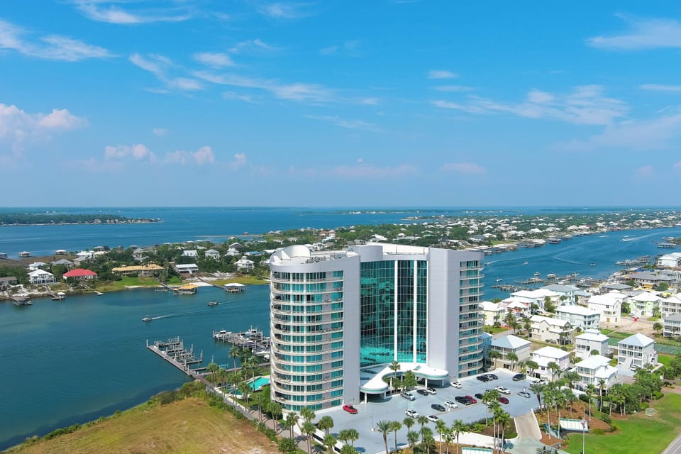 A serene marina scene unfolds, with the vast expanse of the Gulf of Mexico providing a breathtaking backdrop. The gentle rhythm of the bay meets the boundless energy of the open sea.