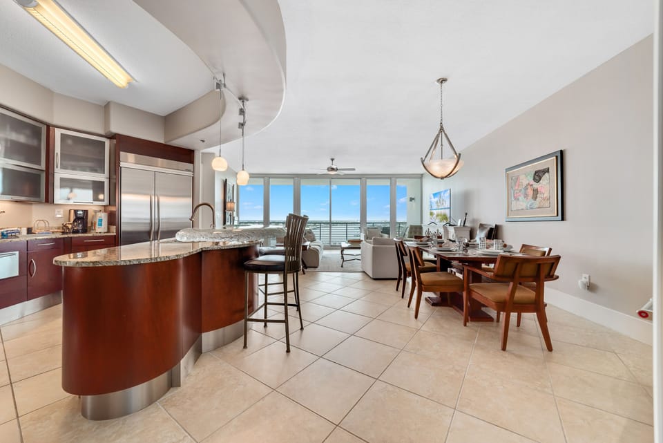 Effortless flow and abundant natural light characterize this stunning condo. The kitchen's thoughtful design and open layout create an inviting atmosphere for both cooking and gathering.