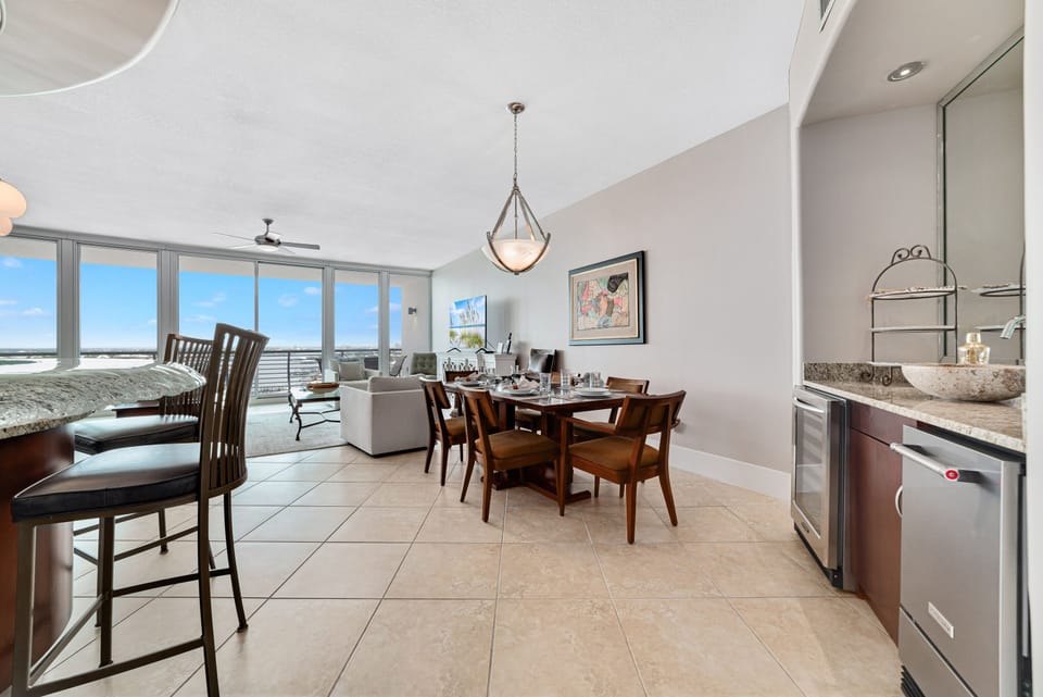 Enjoy effortless entertaining with this well-appointed dining area and wet bar. The integrated wine cooler and blender provide added convenience, while the contemporary design enhances the overall aesthetic.