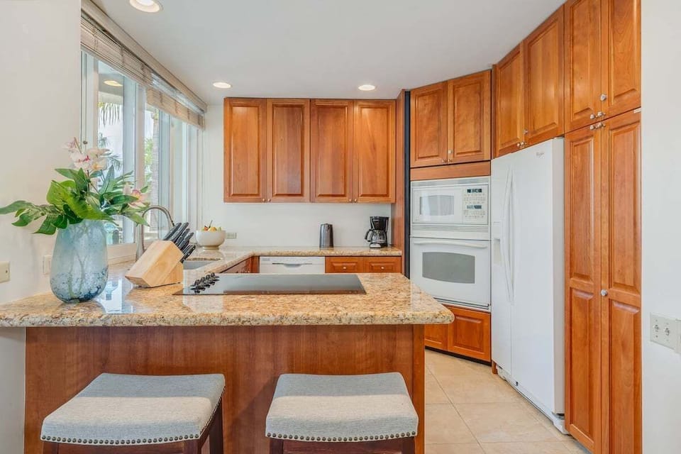 Warm kitchen with granite island and classic cabinetry
