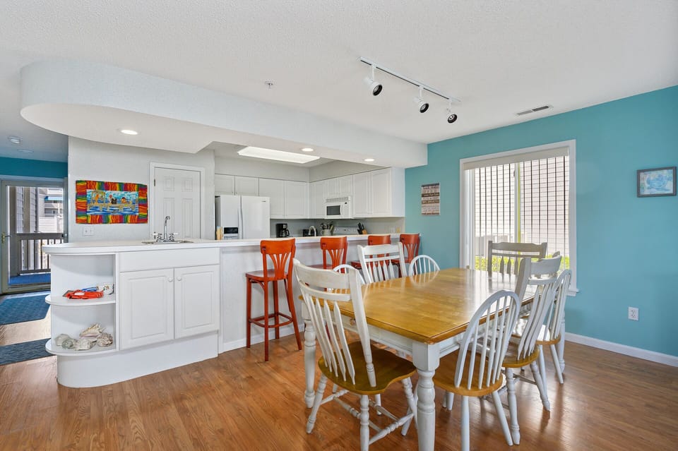 There is plenty of seating for dining inside also witht eh dining table and convenient Breakfast Bar