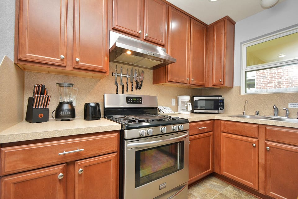 Kitchen with extra amenities:

Coffee maker, blender, microwave, toaster, flatware, dishes, drink glasses, mugs, pots, pans, cutting board, cooking utensils, dish soap, paper towels, cleaning products, oil, sugar, spices, tea, coffee, first aid...