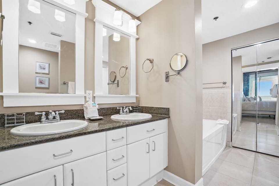 Enjoy dual vanities with abundant storage and natural light in your spacious master bathroom retreat.