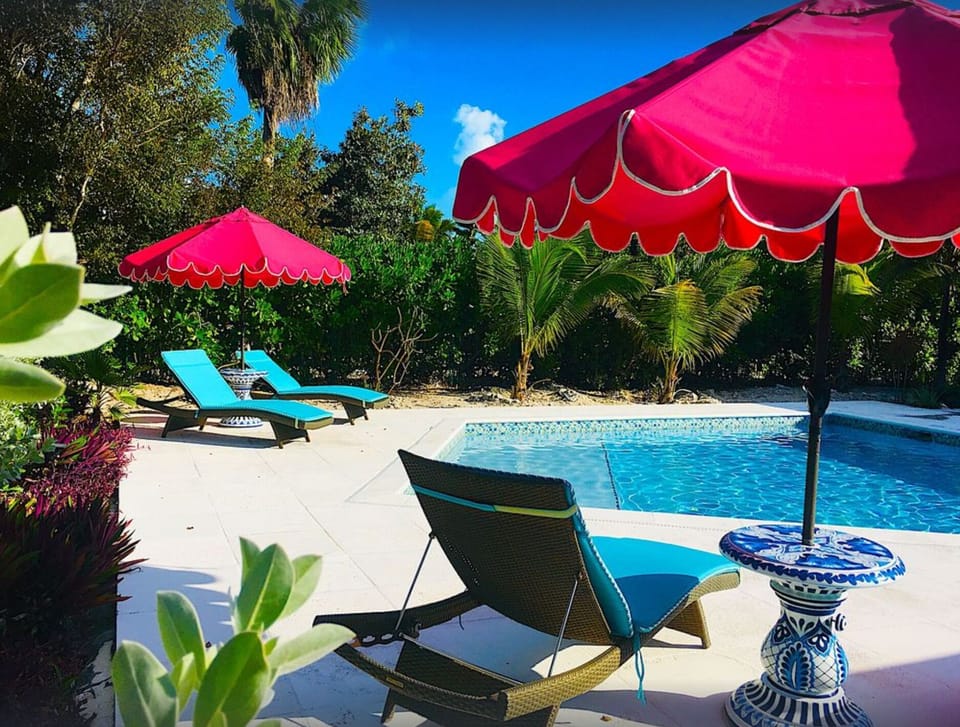 Six loungers and fun pink umbrellas around a large deck