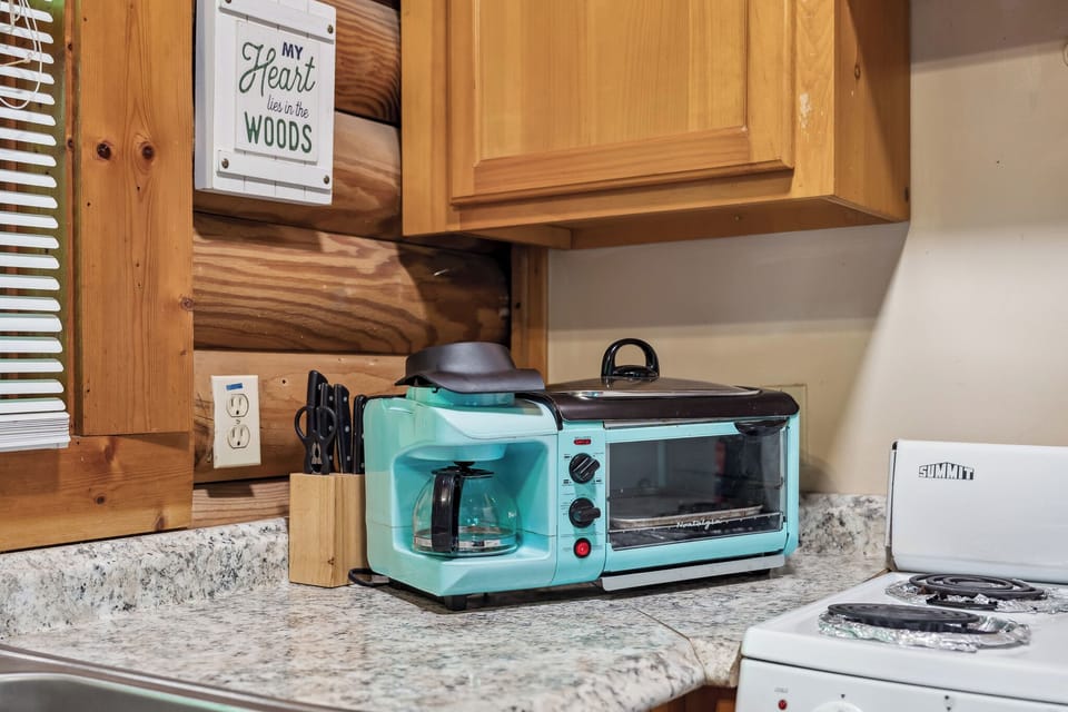 Morning essentials? Coffee maker, toaster, and all the cozy cabin feels.