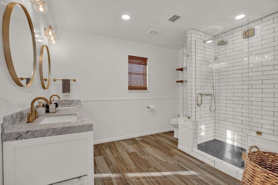 Enjoy the spacious bathroom with a double sink and a walk-in shower.