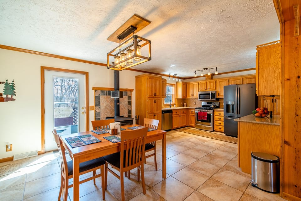 The Open-concept kitchen and dining room offer a convenient space for meal time or family game night