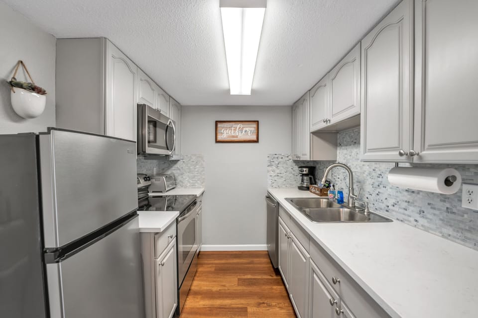 The modern, galley style kitchen comes fully equipped with everything you need