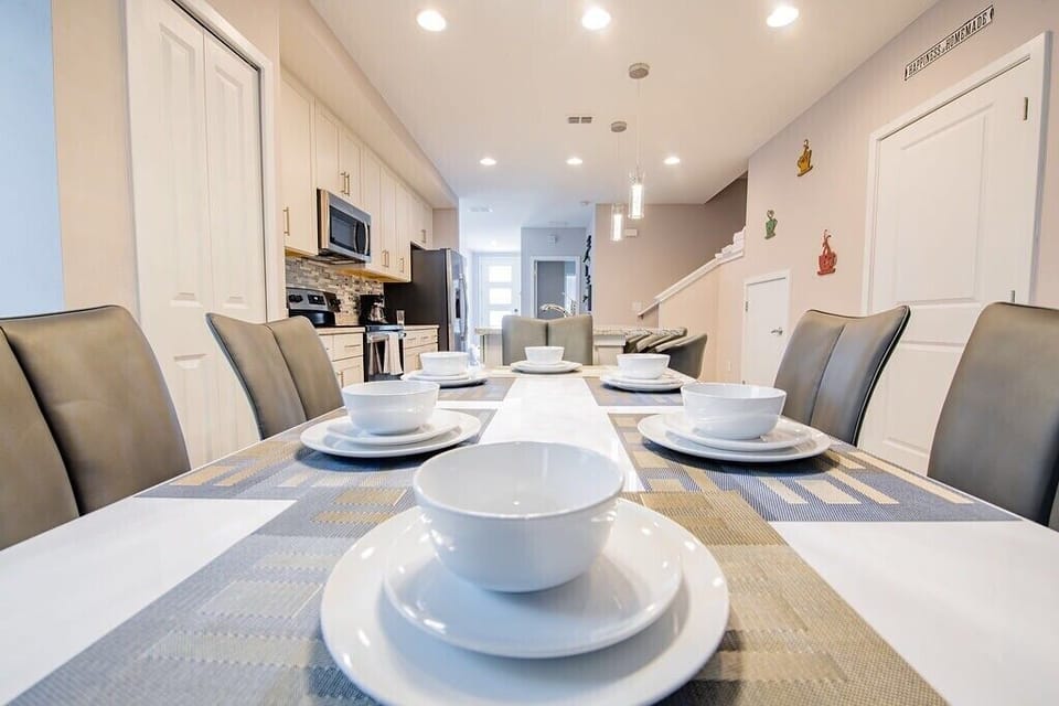 This is our stunning  dining room, where beauty and warmth collide in a symphony of elegance. This vibrant space exudes an inviting charm, perfect for gathering with loved ones over delicious meals. With its spacious layout and comfortable seating, it's the ideal setting for creating unforgettable vacation memories with family and friends.