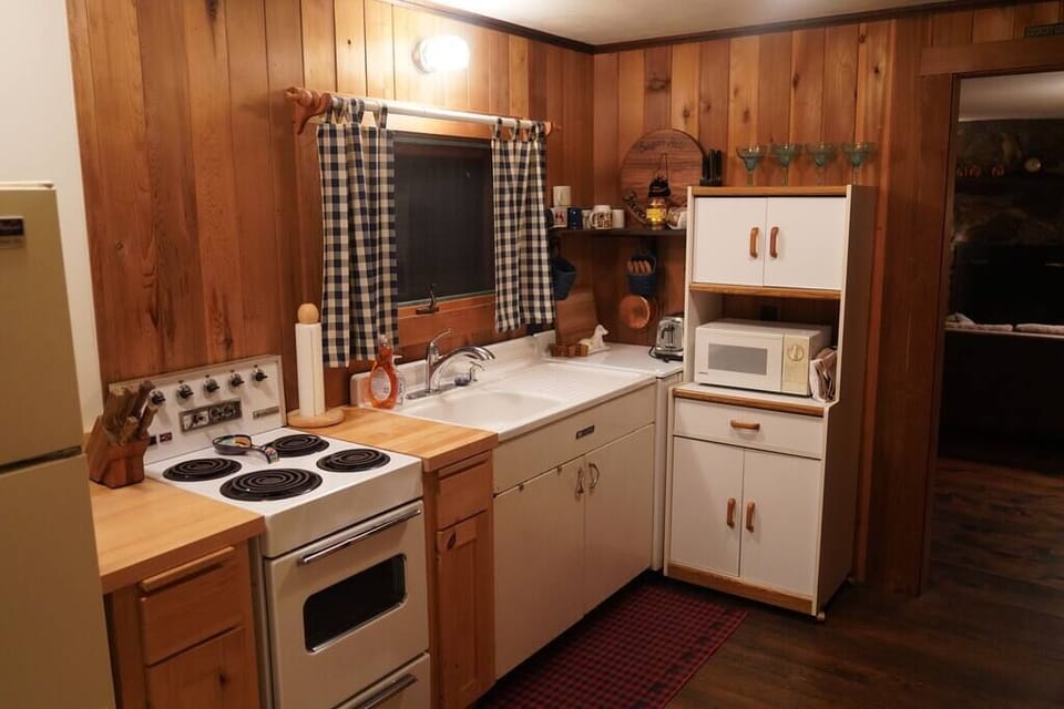 Kitchen with vintage stove and sink.