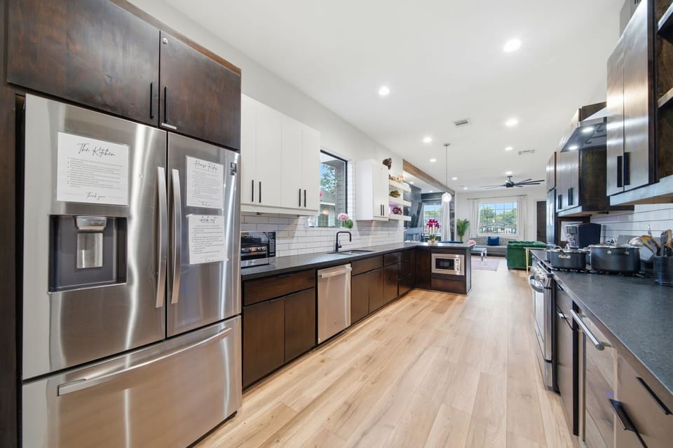 Bright open kitchen with stainless appliances and expansive prep space