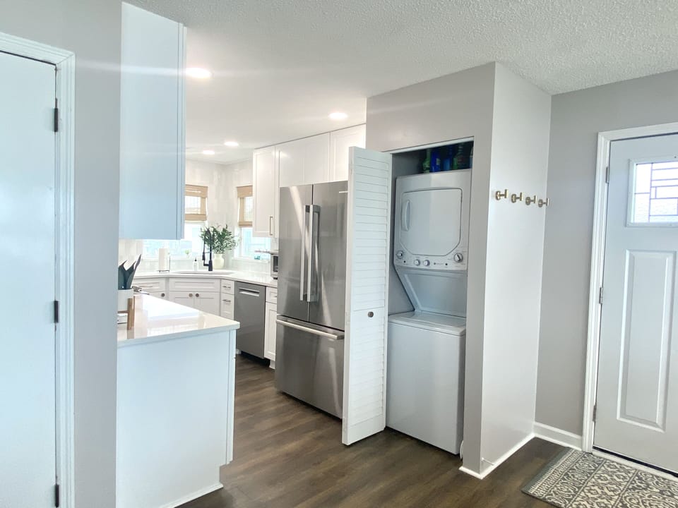 Washer and dryer inside the home, tucked behind closet door.