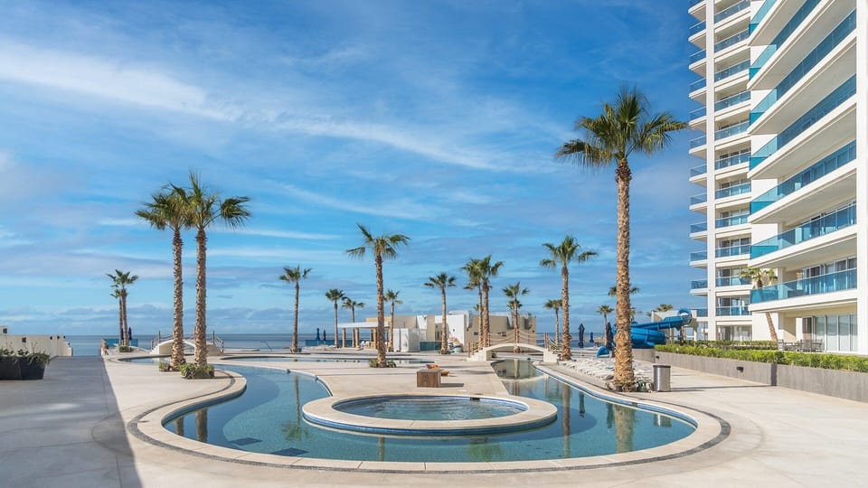 A lazy river winds around a jacuzzi / not tub.