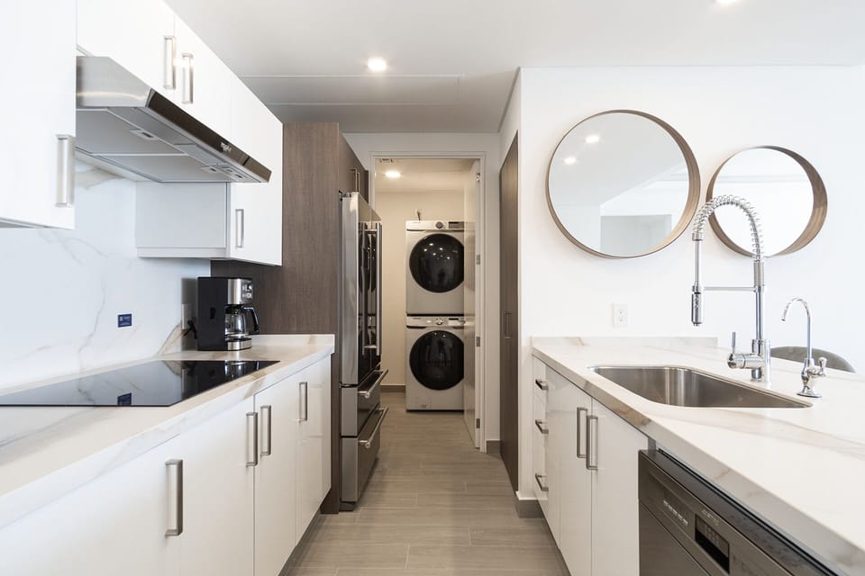 The complete kitchen and a view of the washer and dryer.