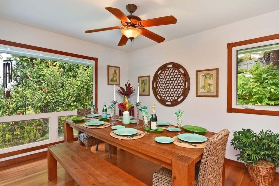 Elegant dining space featuring woven chairs, a wooden bench, and natural decor.