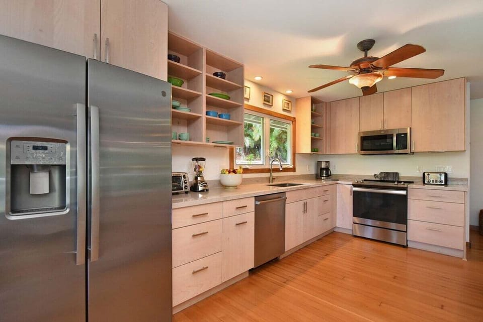 Prepare meals in a spacious kitchen with sleek design and island charm.
