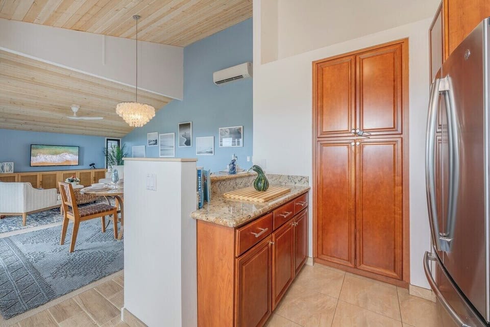 Dining and kitchens extend the design, chandeliers and cabinets keeping the harmony.
