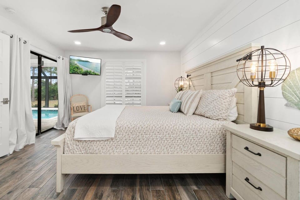 The primary bedroom also features lanai slider access and a flat screen tv.