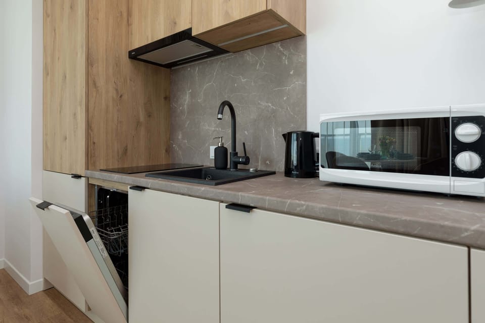 Functional kitchen with dishwasher and microwave. The whole creates a comfortable space for preparing home-cooked meals.