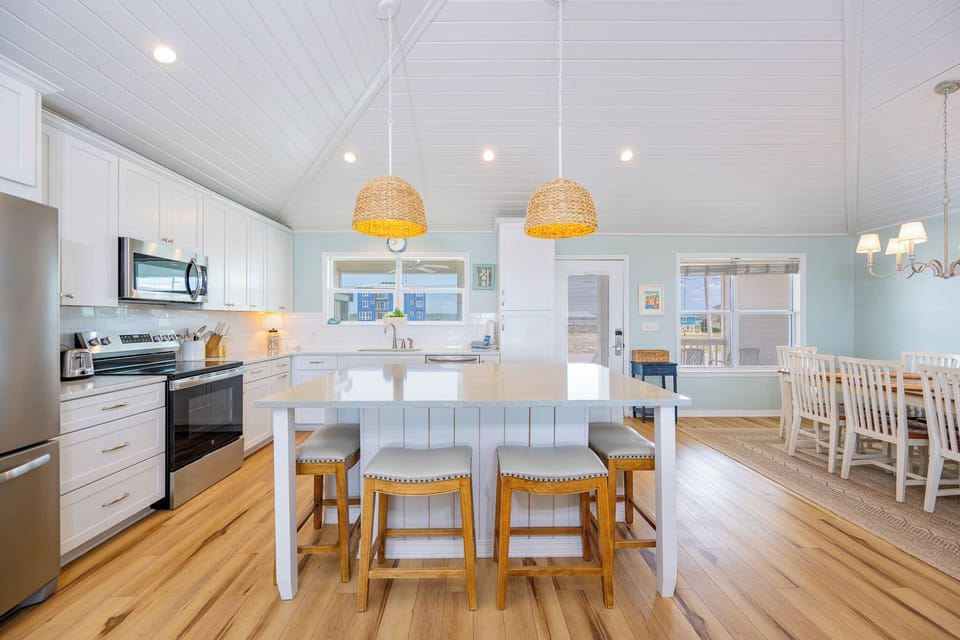 Island seating invites laughter and conversation while you prepare meals in the bright kitchen