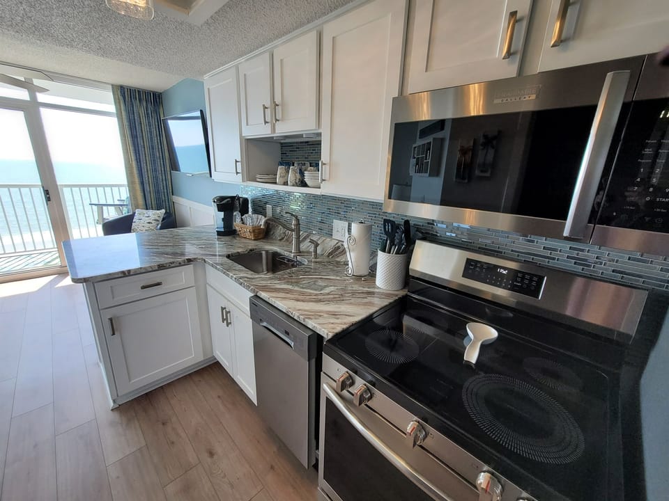 Sleek kitchen w/ bright light & plenty of prep space.