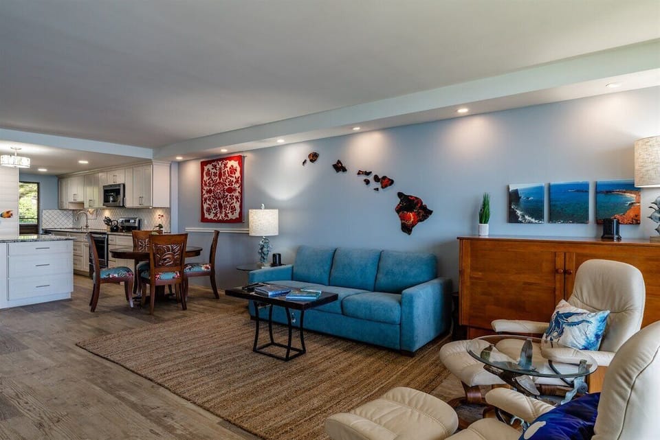 Comfortable living space with a cozy couch & stylish decor, flowing into the dining & kitchen areas.