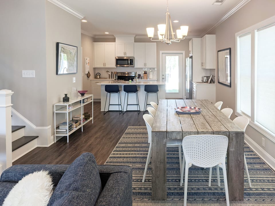 Dining room and kitchen. Dining table seats eight, plus three at kitchen island.