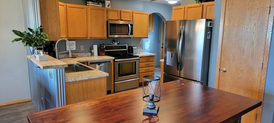 Kitchen featuring large French door refrigerator, oven/stove & dishwasher