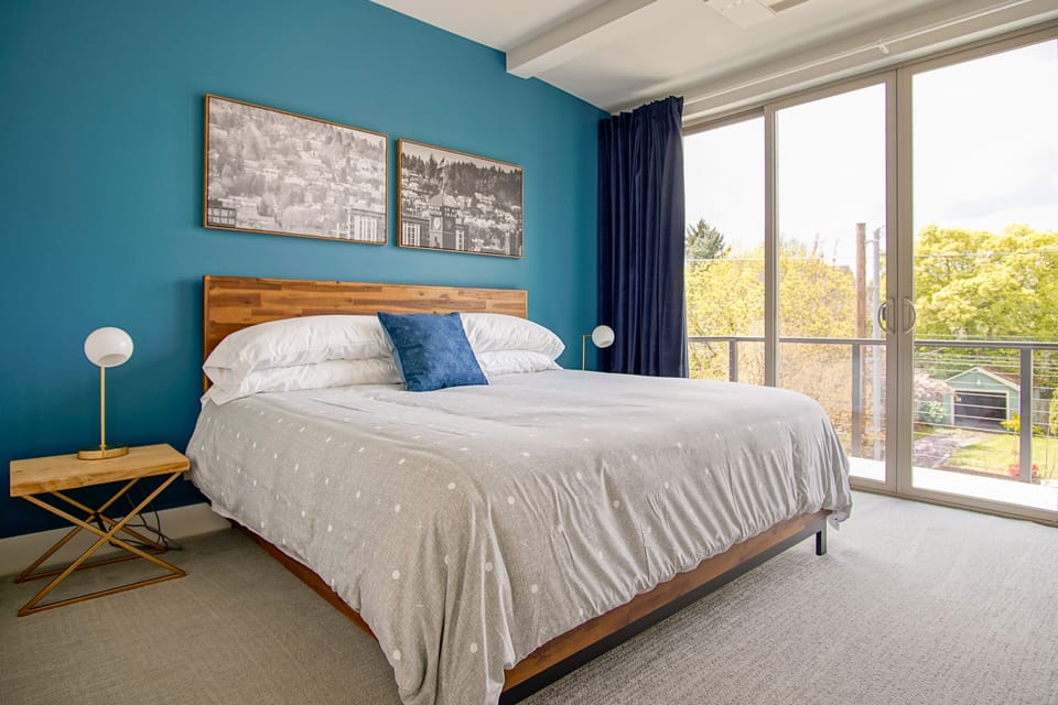 King bedroom with private balcony overlooking the beautiful tree-lined street.