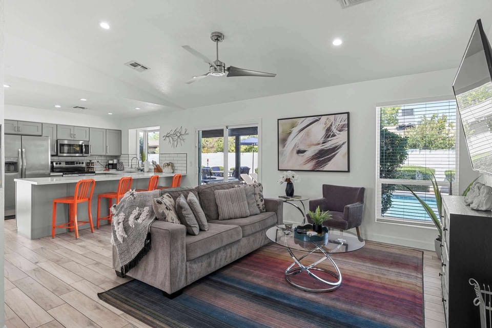 Stylish open-concept living with pool views and easy kitchen access—perfect for entertaining.