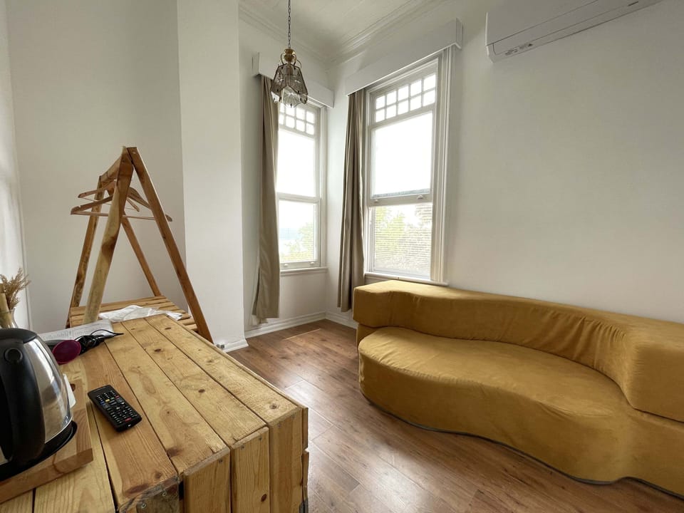 Deluxe Triple Room, 1 Bedroom, Non Smoking | Living area | 32-inch LCD TV with satellite channels