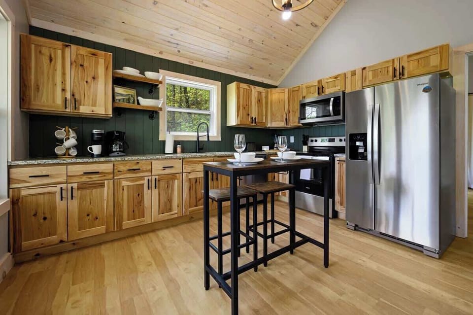 Cook like a pro in the fully stocked kitchen with granite countertops, modern appliances, and rustic wood cabinetry.