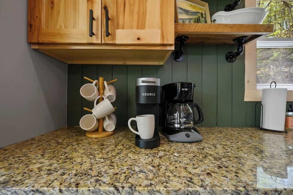 Granite countertops and a curated coffee station make your caffeine fix feel like a cozy ritual.