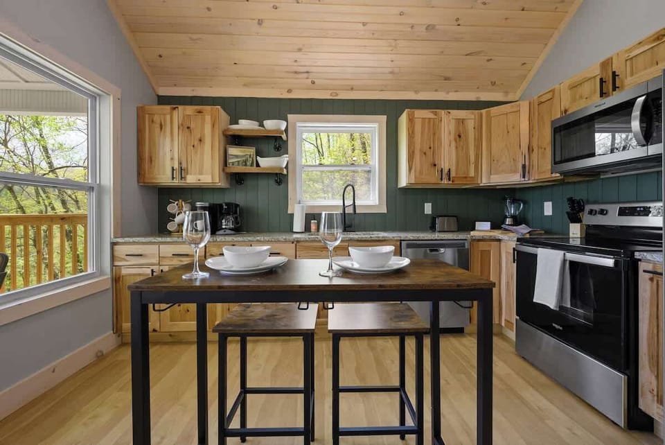 Bright and open kitchen with forest views, perfect for cooking while soaking in the mountain vibes.