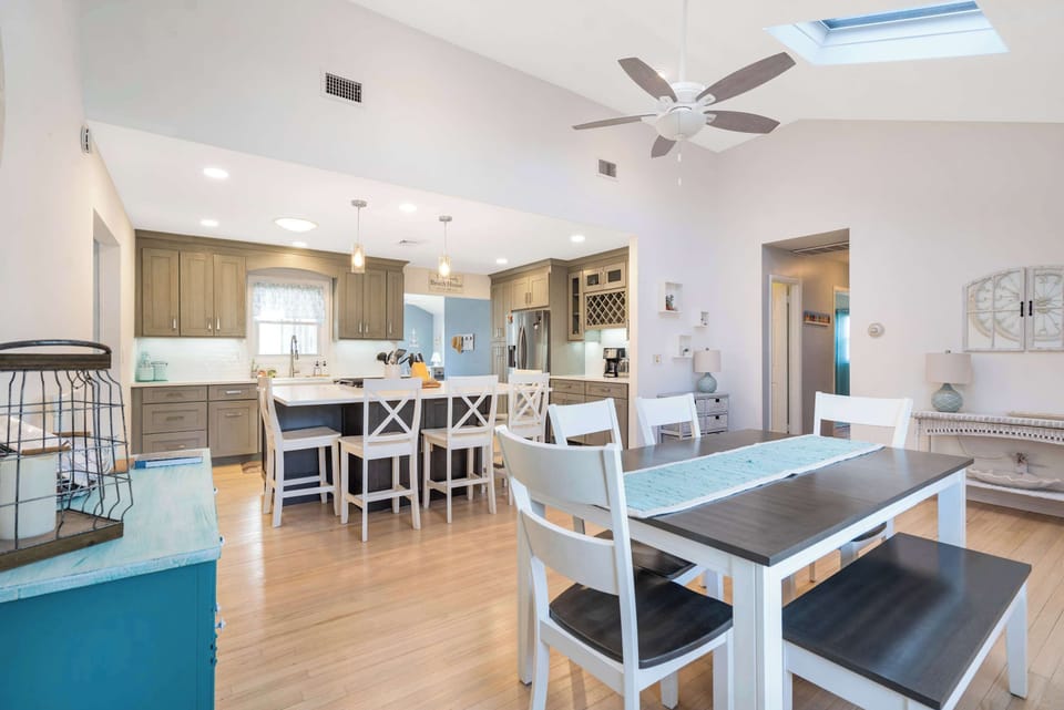 Open kitchen and dining with skylight and coastal accents