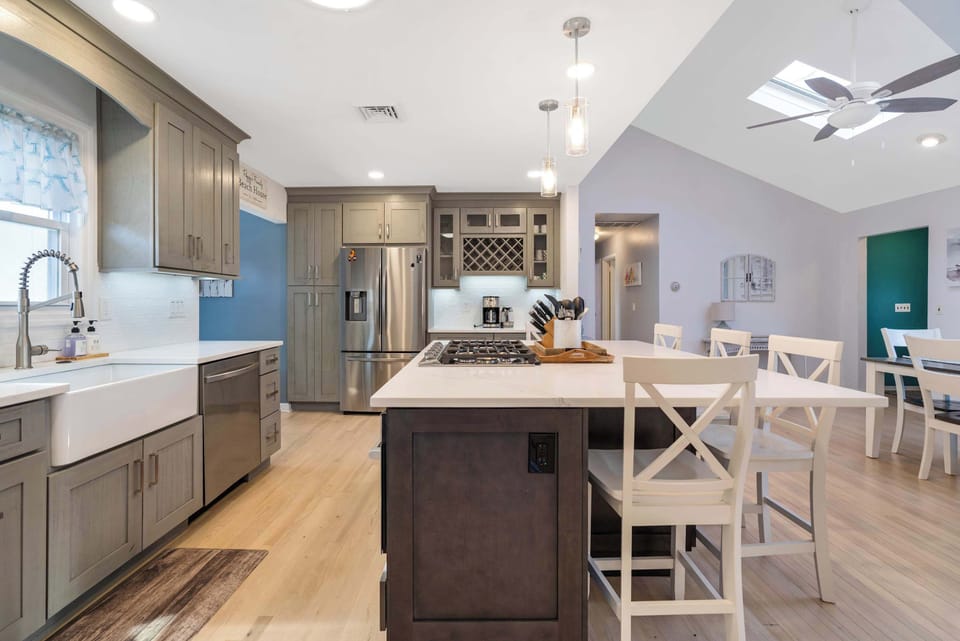 Kitchen with cooktop island and skylights