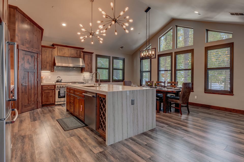 - Open kitchen and dining area with vaulted ceiling  
- Spacious layout with modern lighting and seating  
- Large island for meal prep and family gatherings