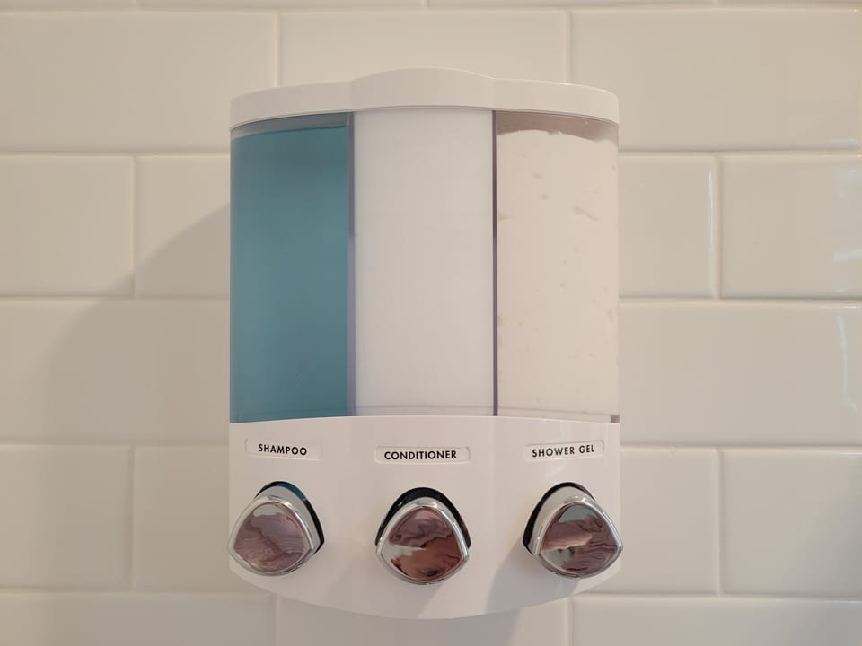 shampoo, conditioner, body wash in both showers