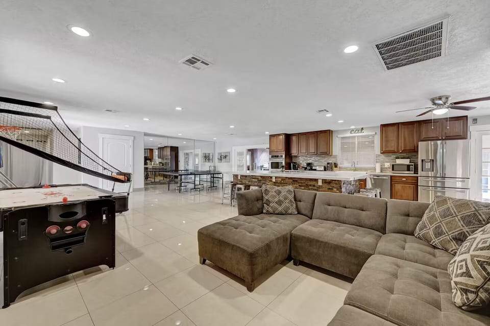 Large Couch and TV with Air Hockey and 2 player arcade style basketball.
