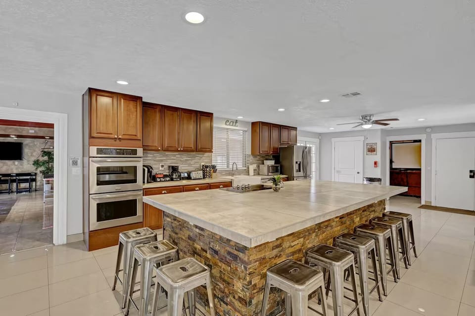 Large Kitchen, double oven, microwave, cooktop, fridge, and room for 12 to sit 