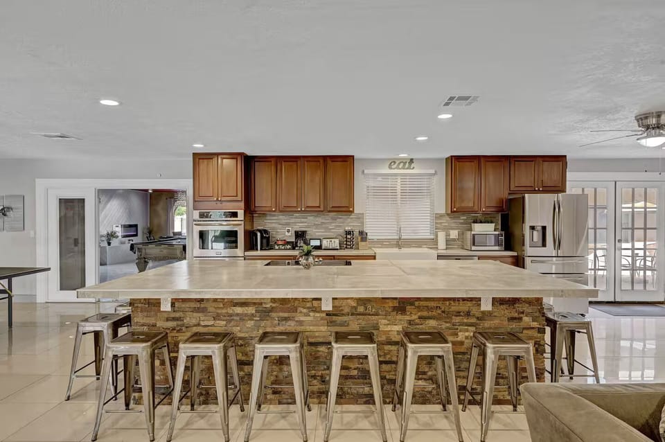 Large Kitchen, double oven, microwave, cooktop, fridge, and room for 12 to sit 