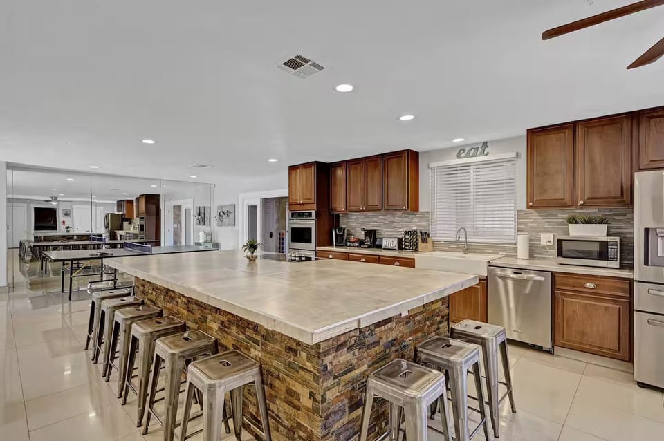 Large Kitchen, double oven, microwave, cooktop, fridge, and room for 12 to sit 