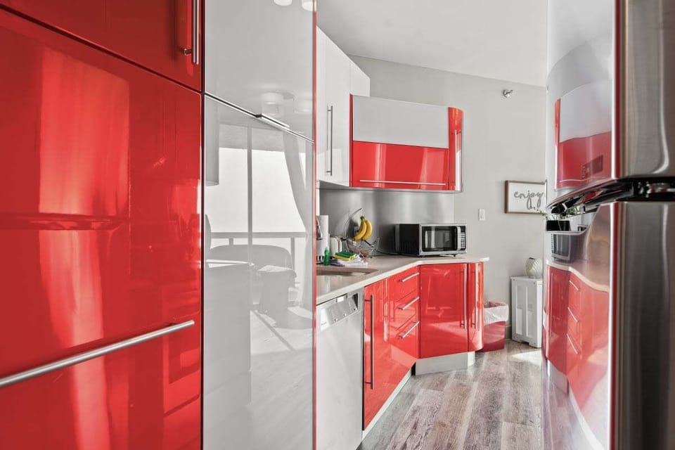 Kitchen with custom lacquered cabinets and stone countertops