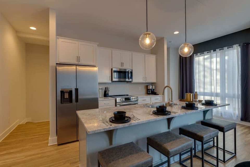 The kitchen features a spacious island with seating for four, perfect for casual meals and entertaining