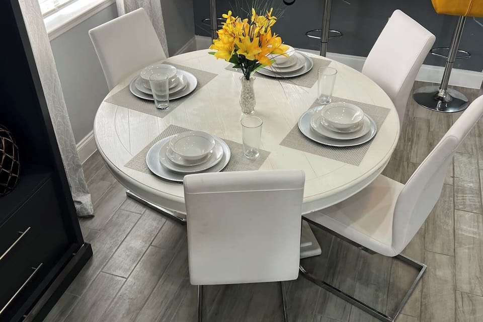 Gather around this welcoming dining table for four, ideal for morning coffee, family meals, or relaxing conversations after exploring Houston.