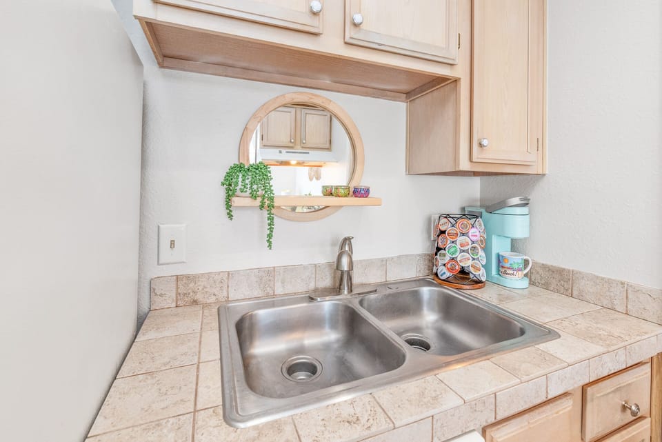 Kitchen with kurig, complimentary variety pack of K cups, cream & sugar 