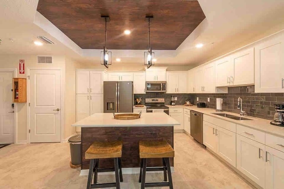 The fully equipped kitchen features modern appliances, sleek cabinetry, and all essential cookware and utensils, making it perfect for preparing meals with ease.
