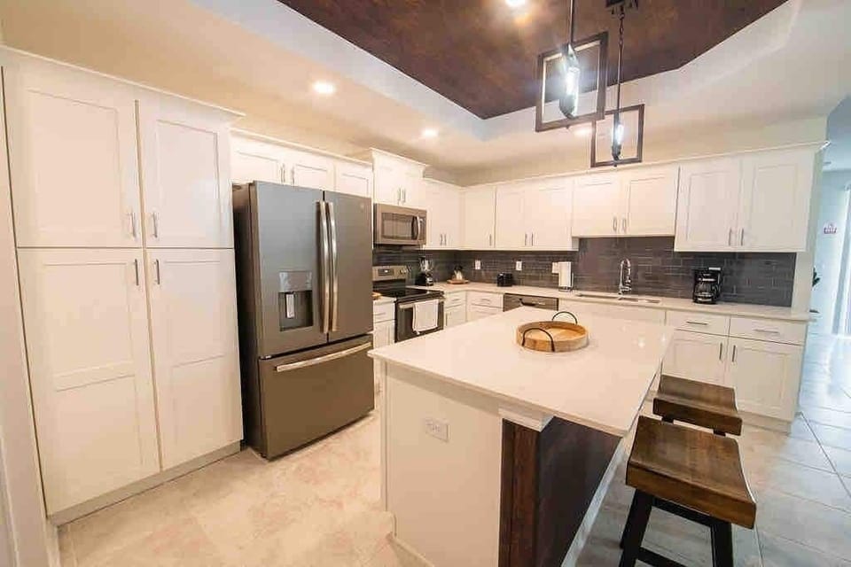 The fully equipped kitchen features modern appliances, sleek cabinetry, and all essential cookware and utensils, making it perfect for preparing meals with ease.